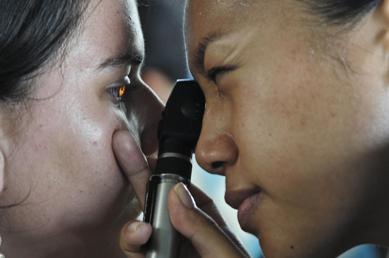 optometrist examining red eye patient