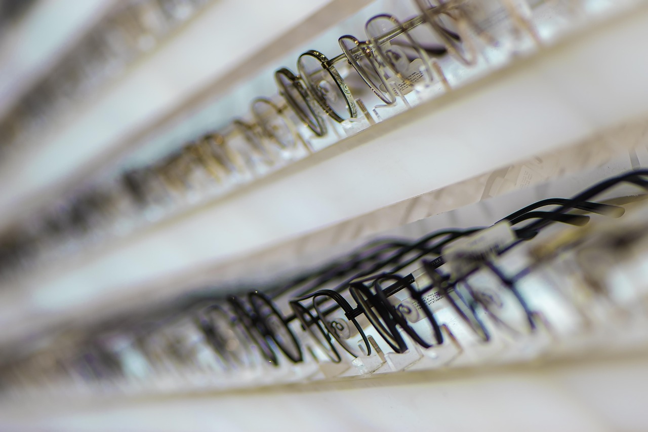 optician cutting eyeglass lens in lab