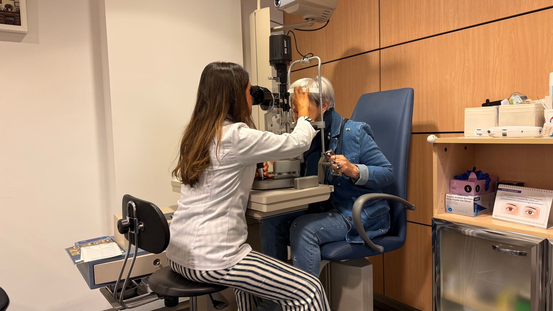 optometrist examining patient in eye clinic